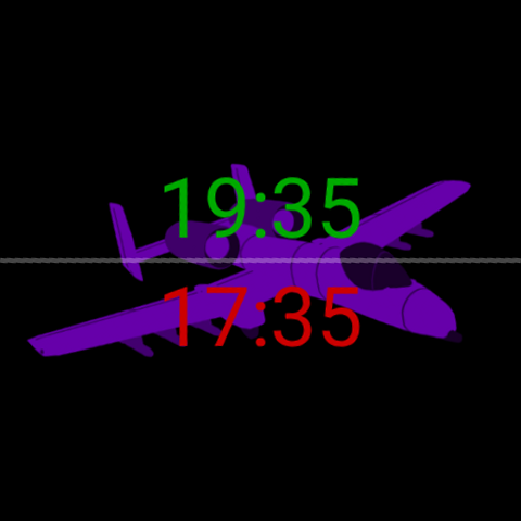 Zulu Face con una silhouette viola di un A-10 Thunderbolt II dietro gli orari: ora locale 19:35 in verde in alto, ora Zulu/UTC 17:35 in rosso in basso, su nero.